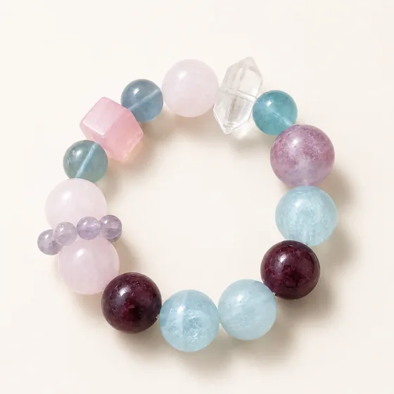 Amethyst, rose quartz, aquamarine and green fluorite, with a double-terminated clear quartz point.