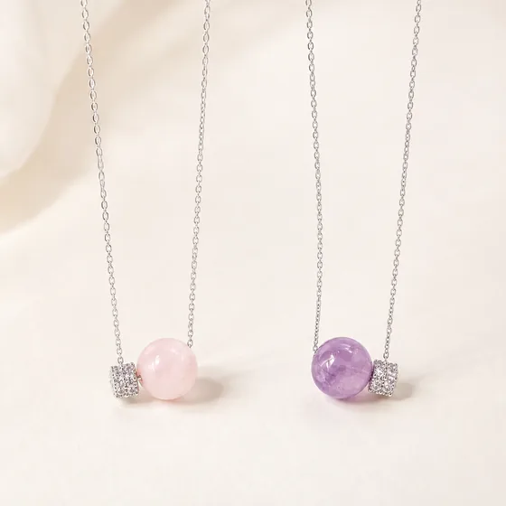 Rose quartz on the left, amethyst on the right, each set beside zircon.